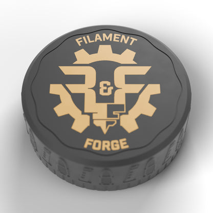 Gold Filament & Forge badge inlaid in the black lid of the F&F 50-round ammo puck
