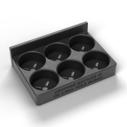 Empty 6-cup dropper bottle block showing the chamfered cups and pressed-in front label
