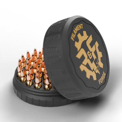 F&F 50-round ammo puck for .22 LR, open with 50 rounds and the gold-badge textured lid leaning beside it
